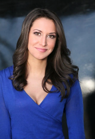 Female comedian for hire Rachel Feinstein in a blue top.